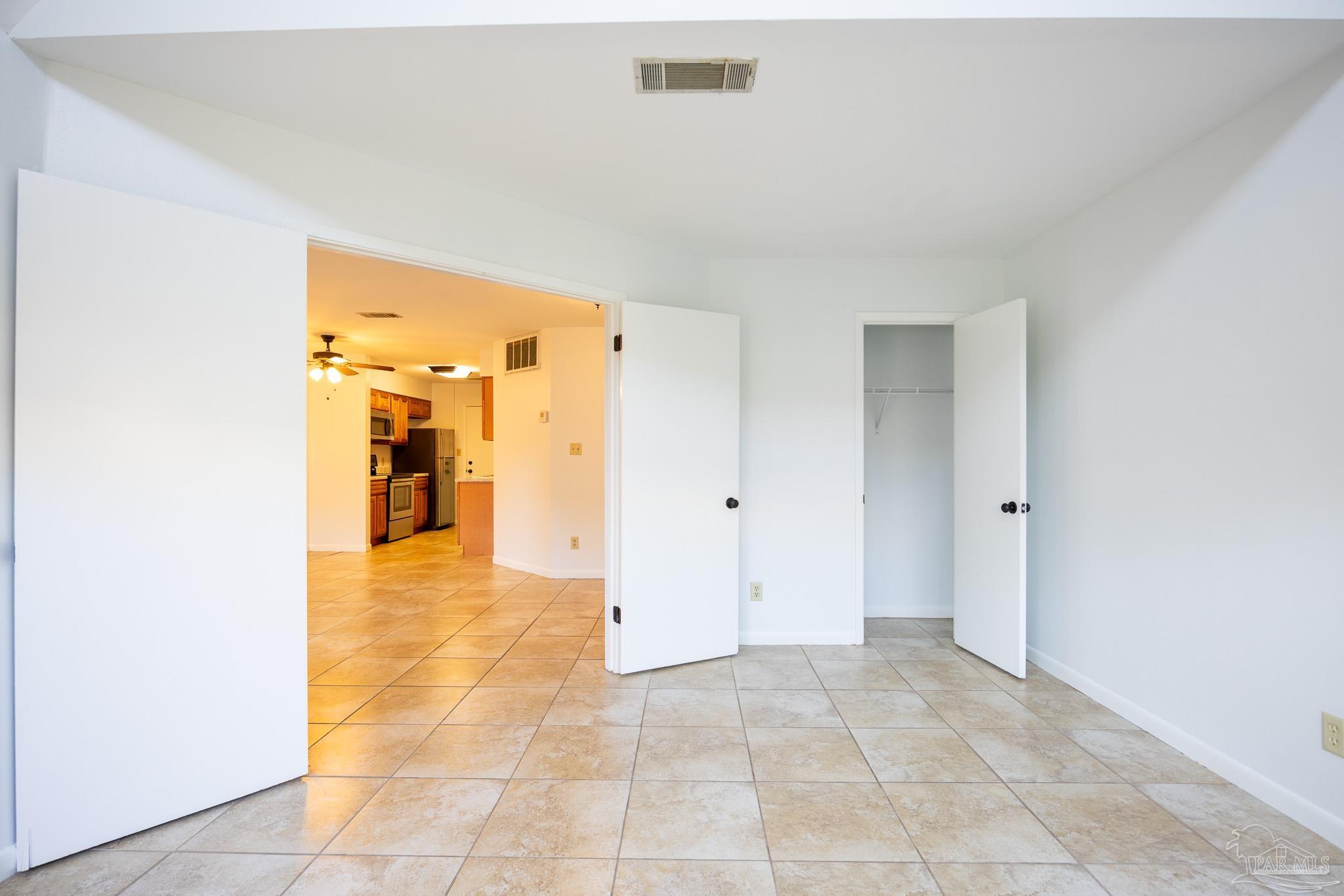 7150 Plantation Road, Unit 312 Pensacola, FL 32504 - Photo 6 of 14 a view of a hallway with wooden shelves