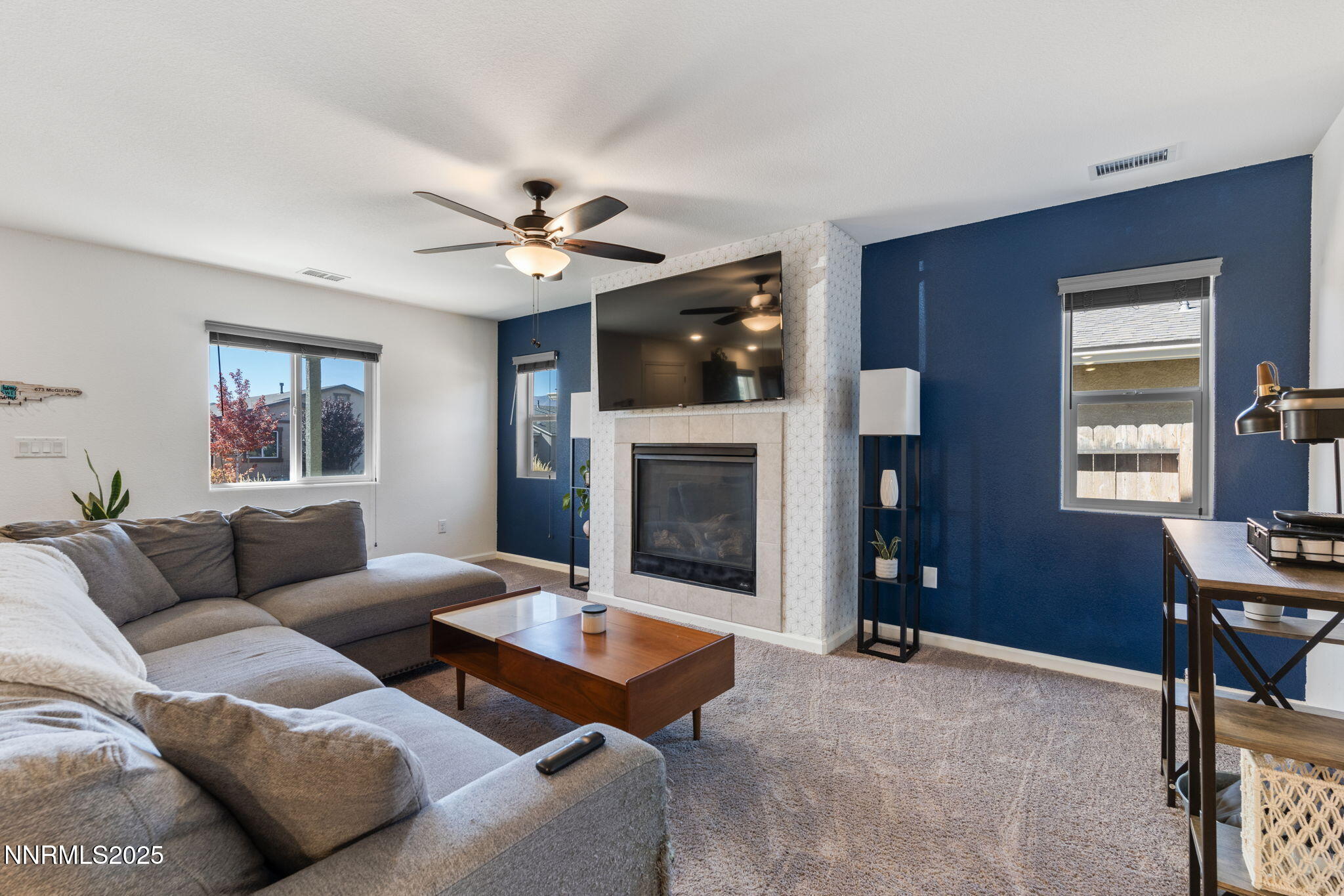 673 Mcgill Drive Reno, NV 89506 - Photo 19 of 34 a living room with furniture a flat screen tv and a fireplace
