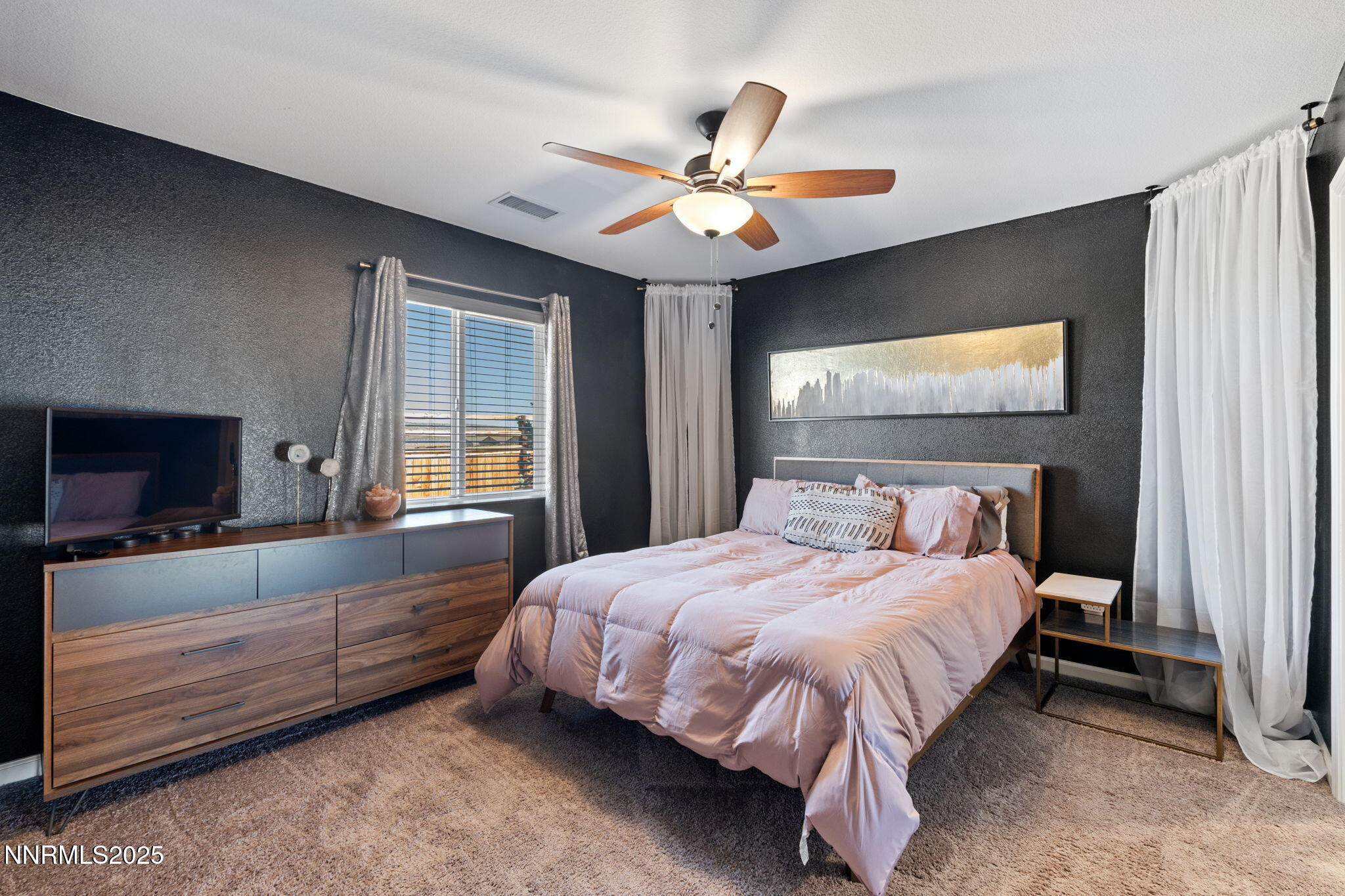 673 Mcgill Drive Reno, NV 89506 - Photo 23 of 34 a bedroom with a bed and a flat screen tv
