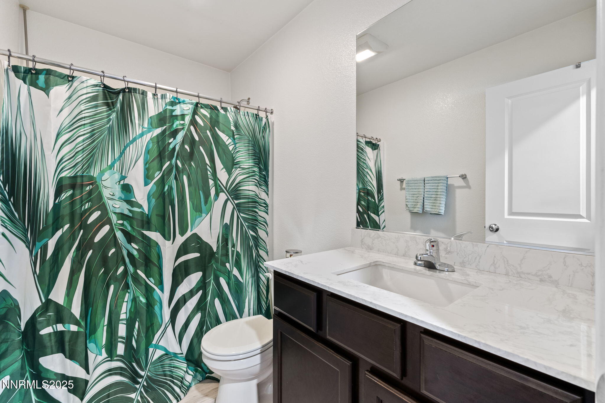 673 Mcgill Drive Reno, NV 89506 - Photo 27 of 34 a bathroom with a sink a toilet and a mirror
