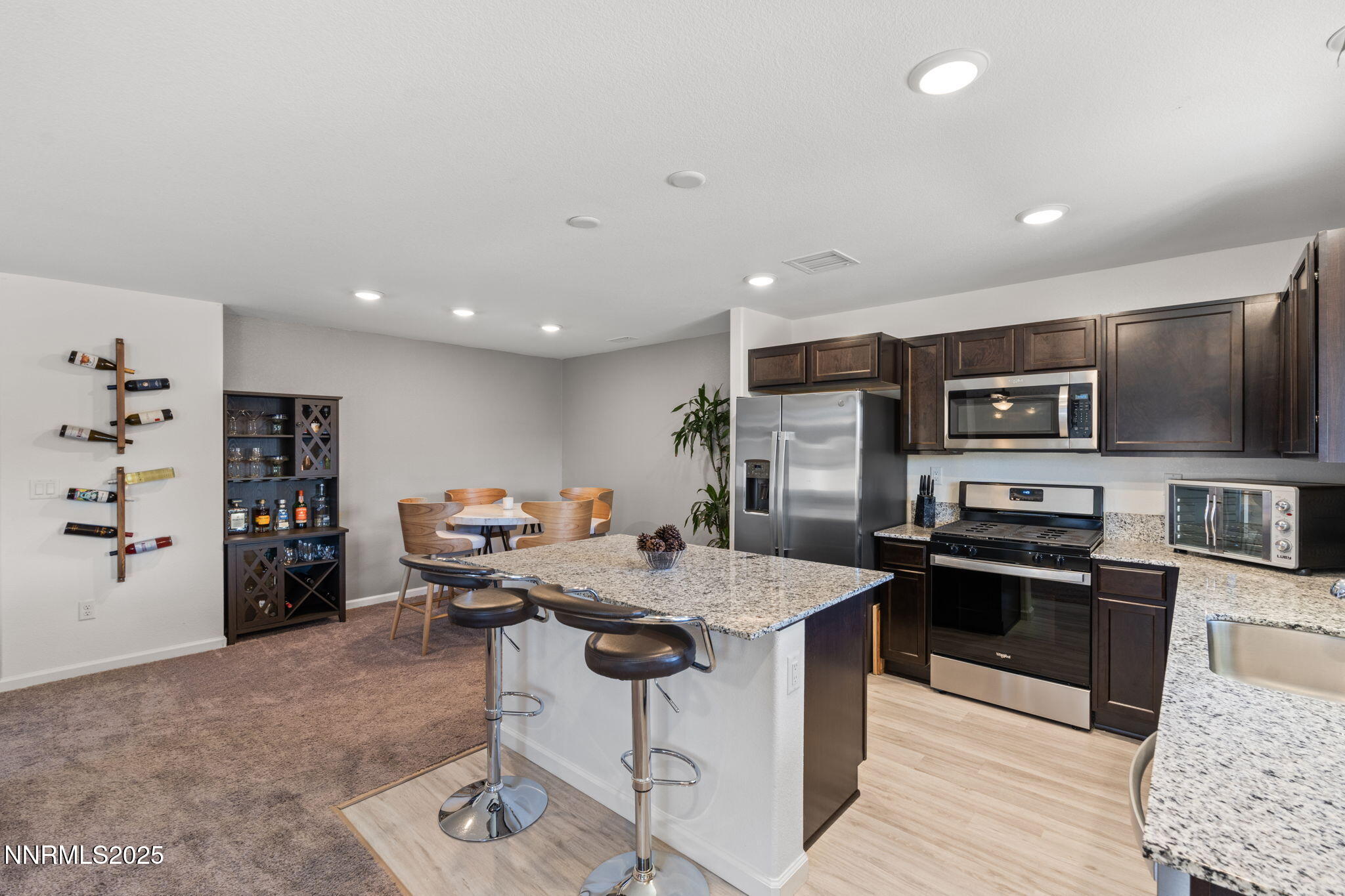 673 Mcgill Drive Reno, NV 89506 - Photo 10 of 34 a kitchen with stainless steel appliances kitchen island granite countertop a sink and a refrigerator