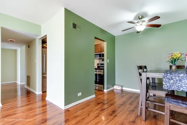 a dining room with furniture and wooden floor