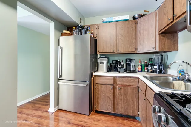 a kitchen with stainless steel appliances granite countertop a refrigerator and a sink