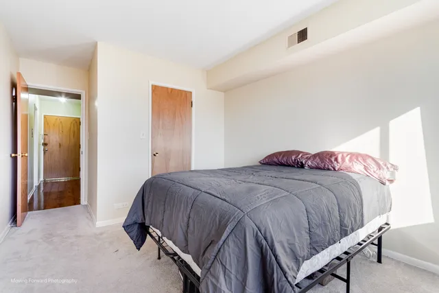 a bedroom with a bed and a television