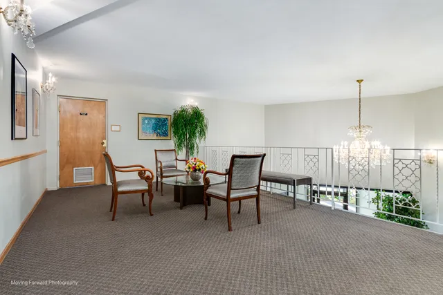 a view of a livingroom with furniture and staircase