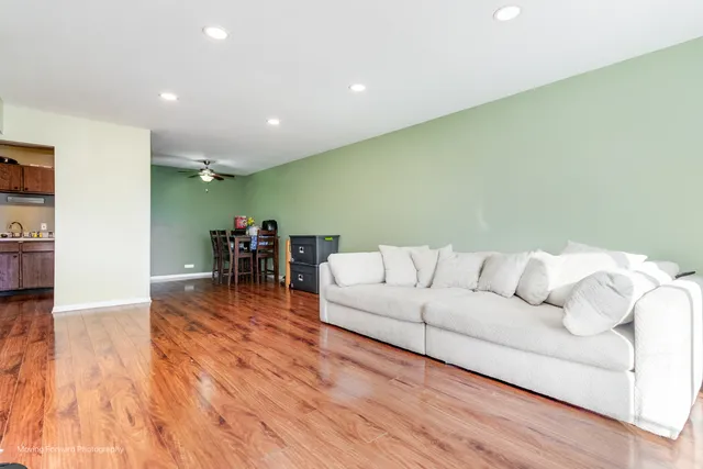 a view of a livingroom with wooden floor and a flat screen tv