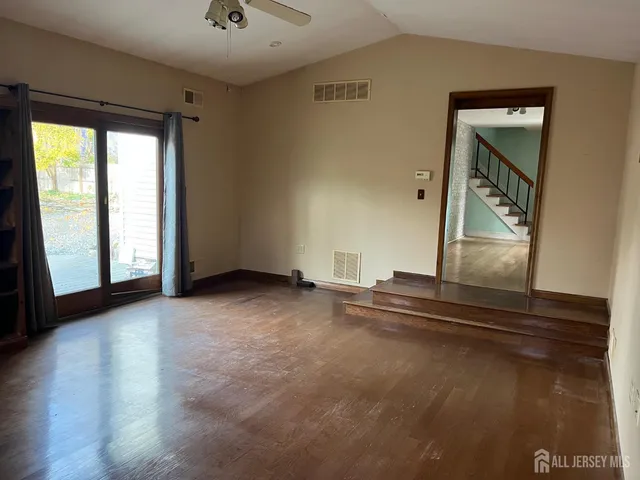 a view of a livingroom with an empty space and a window
