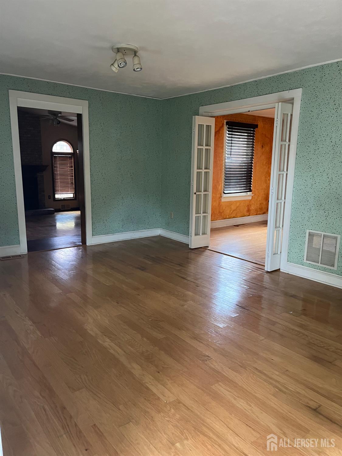 45 Old New Road Monmouth Junction, NJ 08852 - Photo 5 of 22 a view of empty room with wooden floor and fan