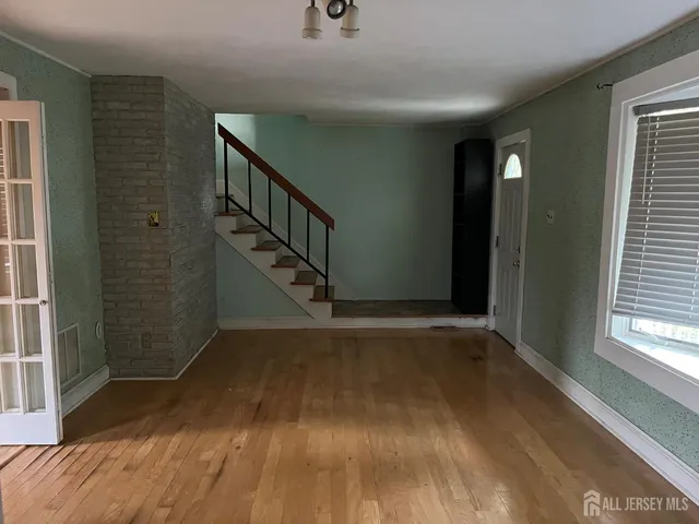 a view of entryway with wooden floor and stairs