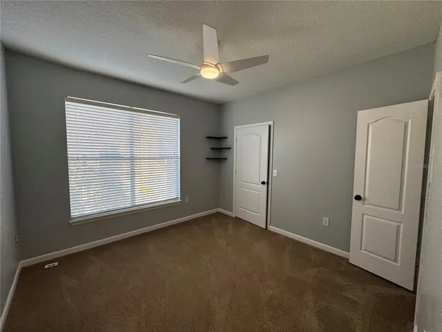 an empty room with windows and closet