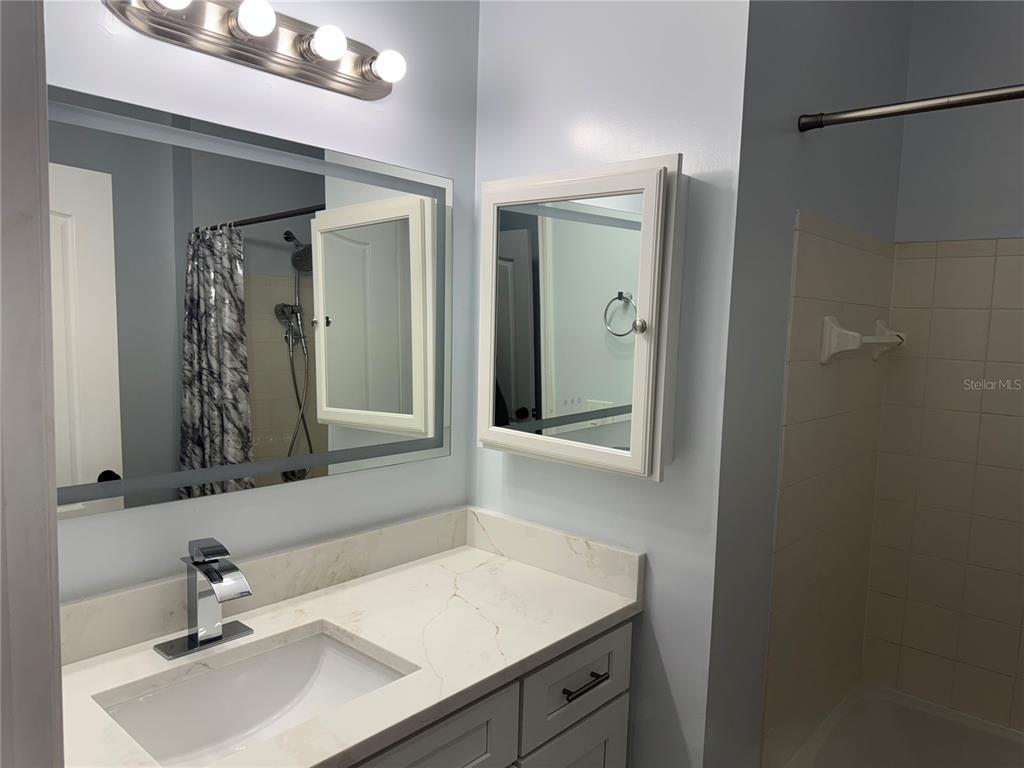 10444 Villa View Circle Tampa, FL 33647 - Photo 15 of 29 a bathroom with a sink and a mirror