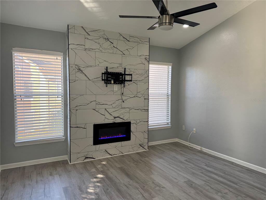 10444 Villa View Circle Tampa, FL 33647 - Photo 8 of 29 an empty room with windows and fireplace