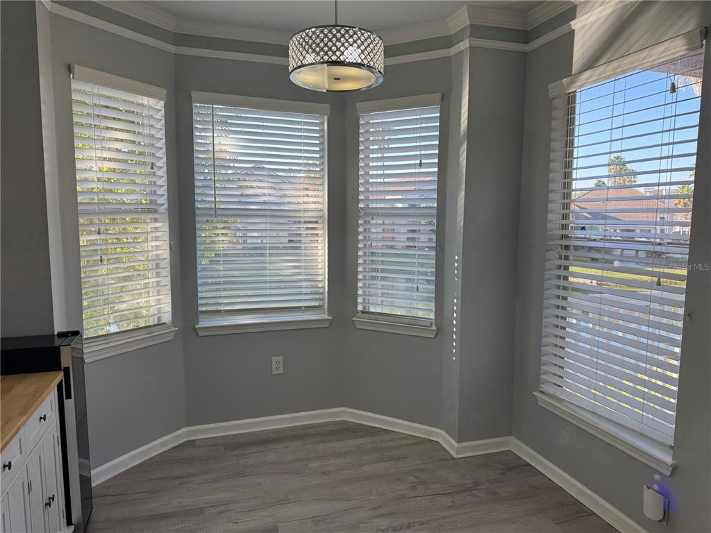10444 Villa View Circle Tampa, FL 33647 - Photo 9 of 29 a view of an empty room with a window and wooden floor