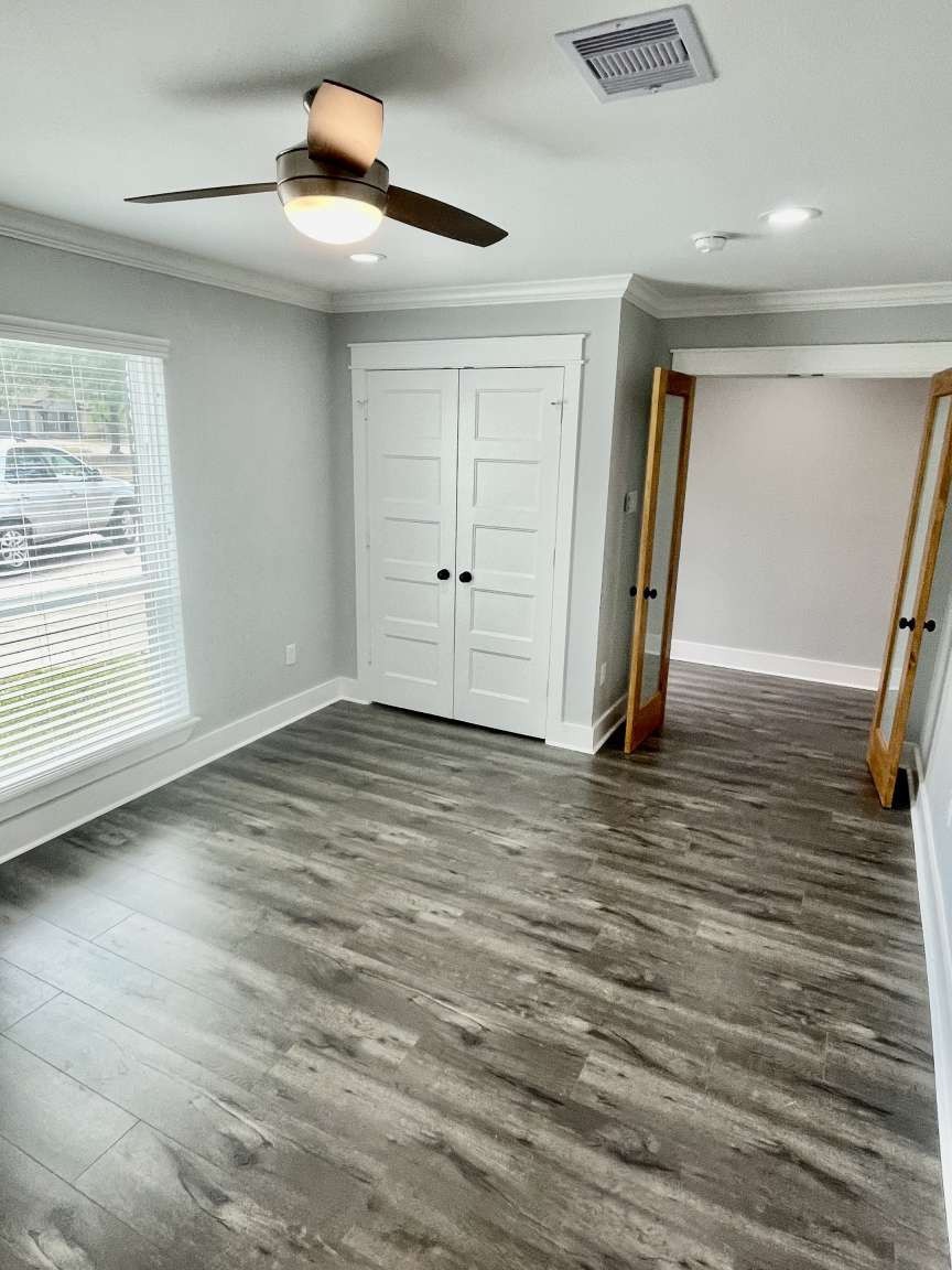 12122 Chimney Rock Road Houston, TX 77035 - Photo 15 of 33 a view of an empty room with wooden floor and a window