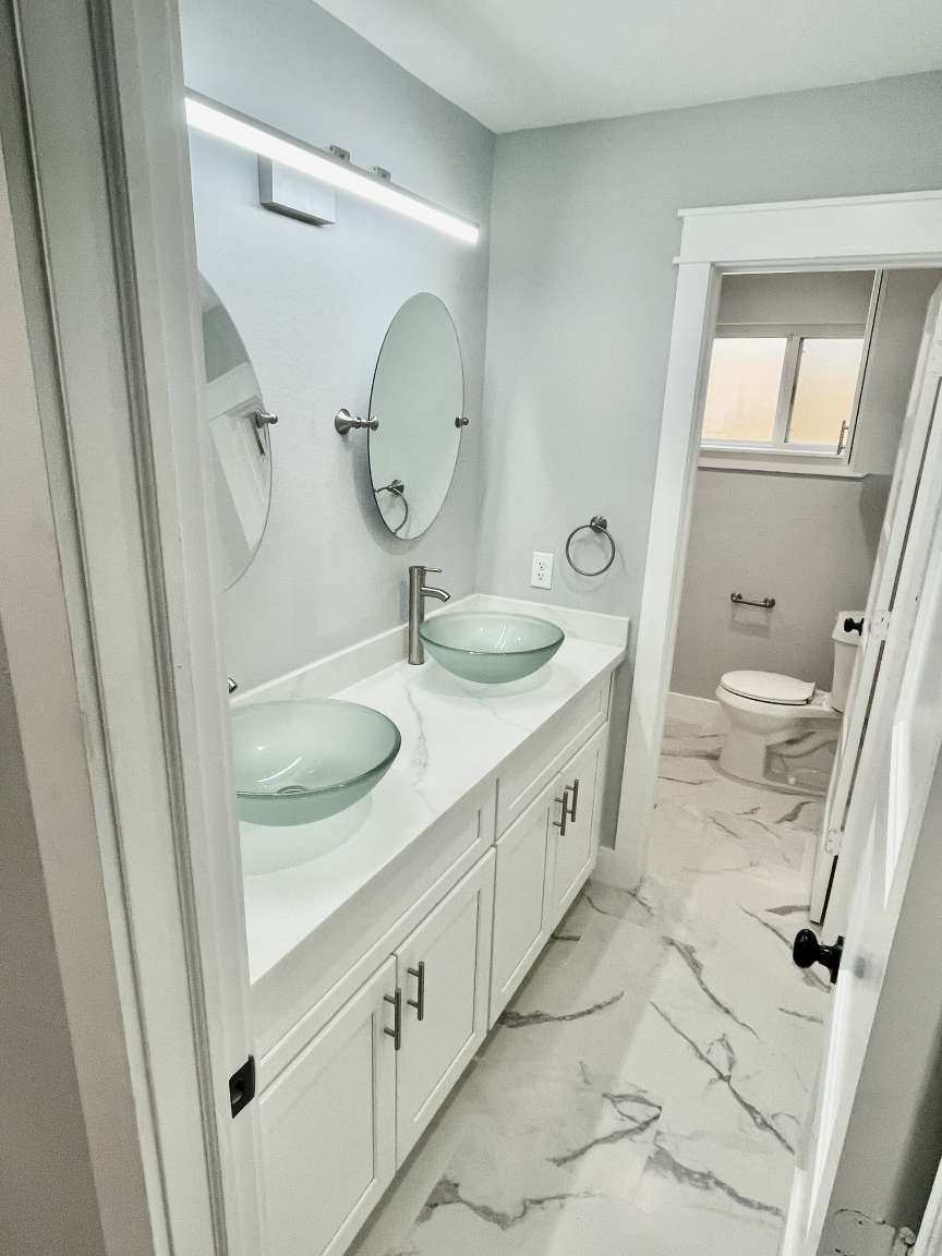 12122 Chimney Rock Road Houston, TX 77035 - Photo 19 of 33 a bathroom with a double vanity sink mirror and toilet