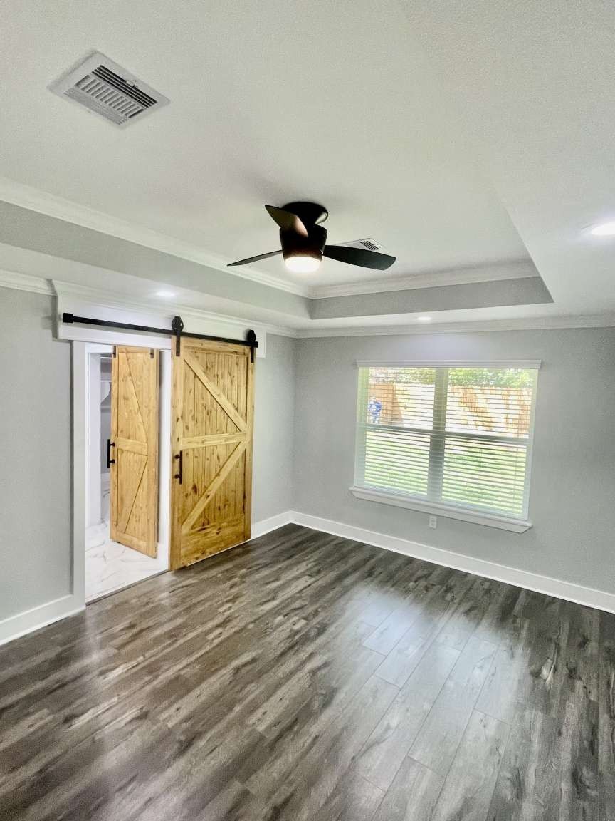 12122 Chimney Rock Road Houston, TX 77035 - Photo 21 of 33 a view of an empty room with wooden floor and a window