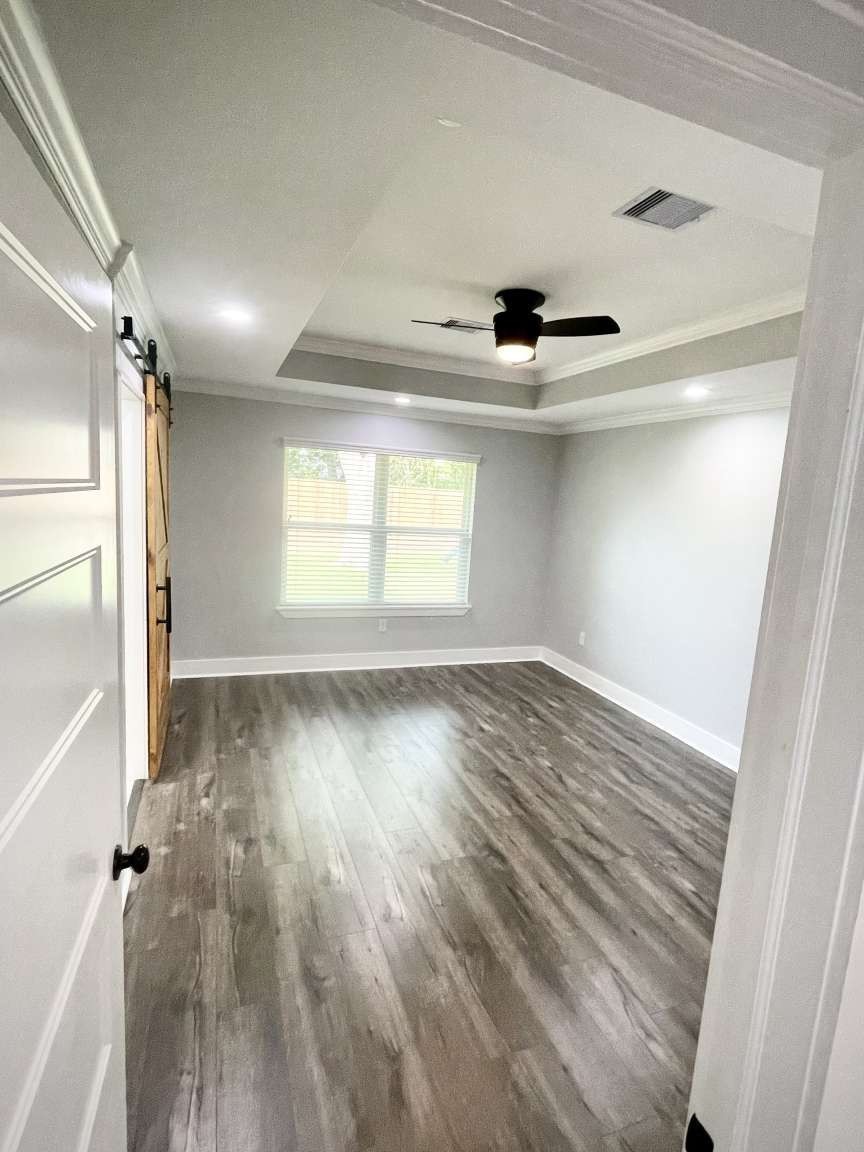 12122 Chimney Rock Road Houston, TX 77035 - Photo 23 of 33 a view of empty room with wooden floor and fan