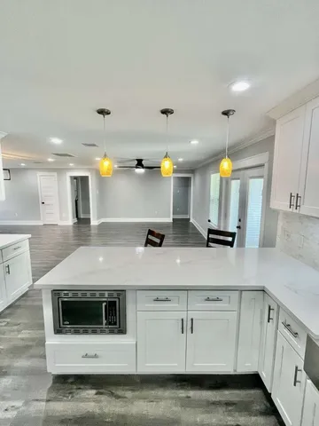 a stove top oven sitting inside of a kitchen