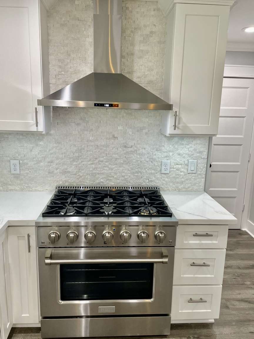 12122 Chimney Rock Road Houston, TX 77035 - Photo 8 of 33 a stove top oven sitting inside of a kitchen