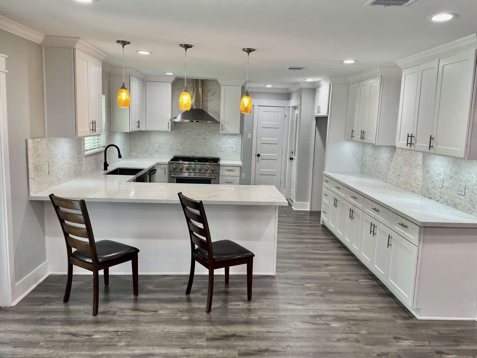 12122 Chimney Rock Road Houston, TX 77035 - Photo 9 of 33 a large kitchen with stainless steel appliances kitchen island granite countertop a table chairs sink and cabinets