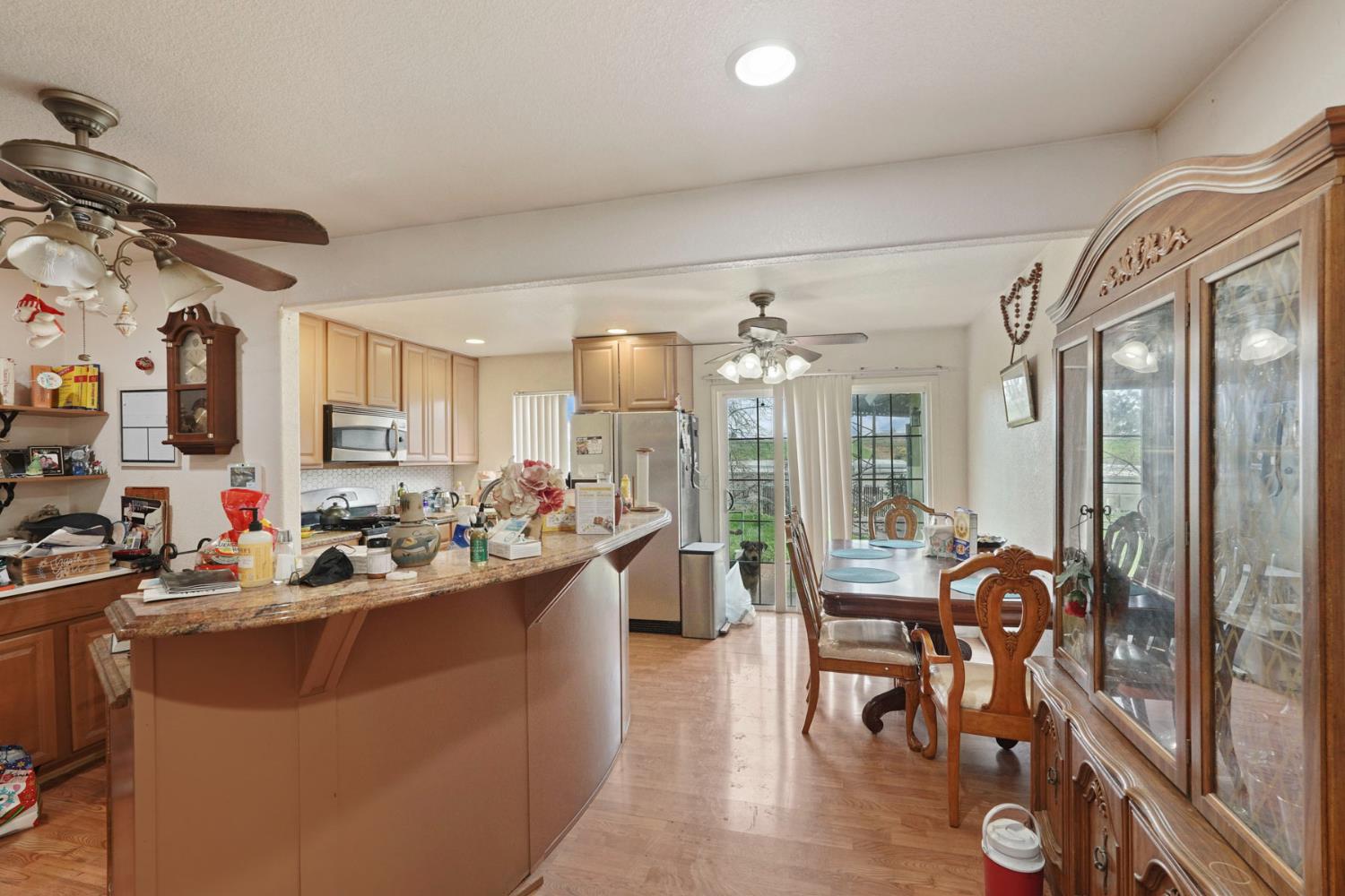 1234 Perry Avenue Stockton, CA 95203 - Photo 12 of 30 a view of a dining room and livingroom with furniture wooden floor a chandelier