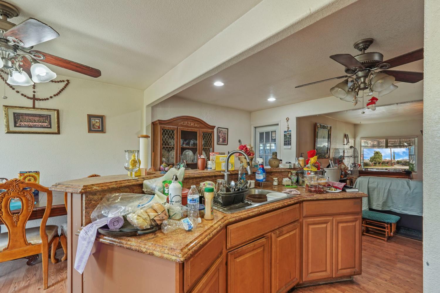 1234 Perry Avenue Stockton, CA 95203 - Photo 14 of 30 a room with stainless steel appliances kitchen island granite countertop a sink and cabinets