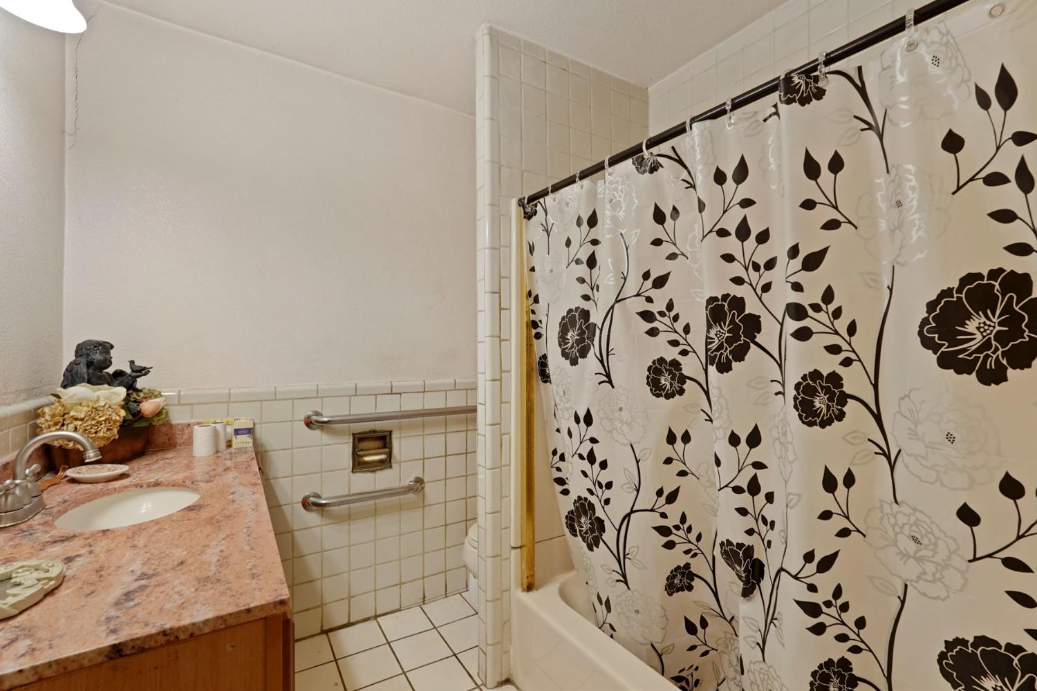 1234 Perry Avenue Stockton, CA 95203 - Photo 19 of 30 a bathroom with a granite countertop sink and a mirror