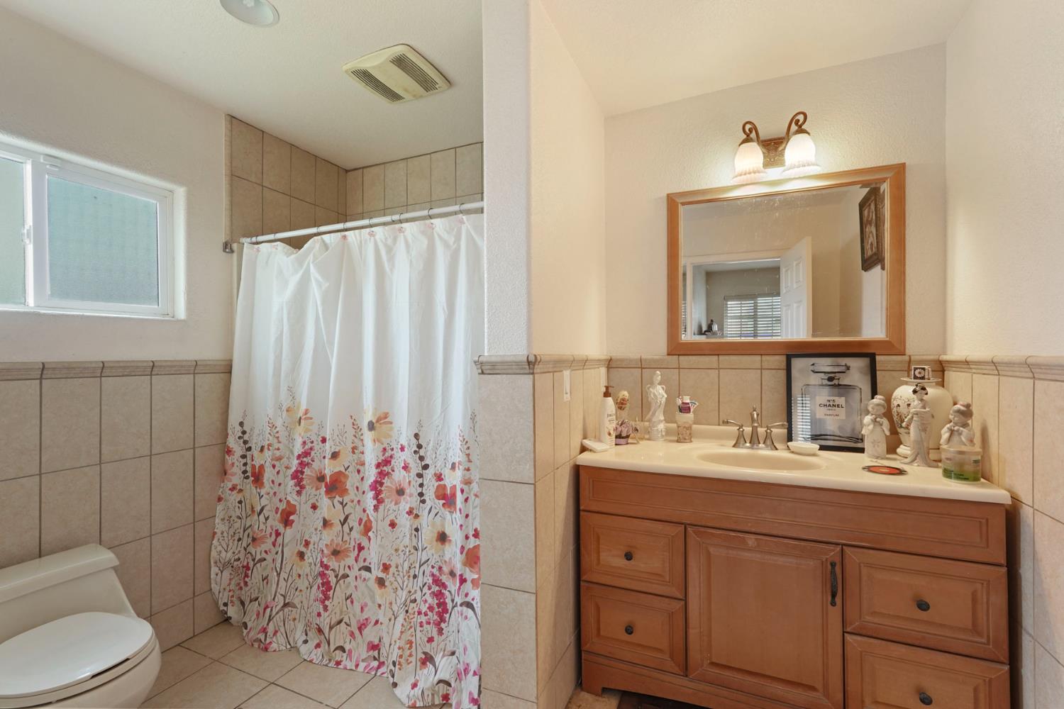 1234 Perry Avenue Stockton, CA 95203 - Photo 23 of 30 a bathroom with a sink mirror and toilet