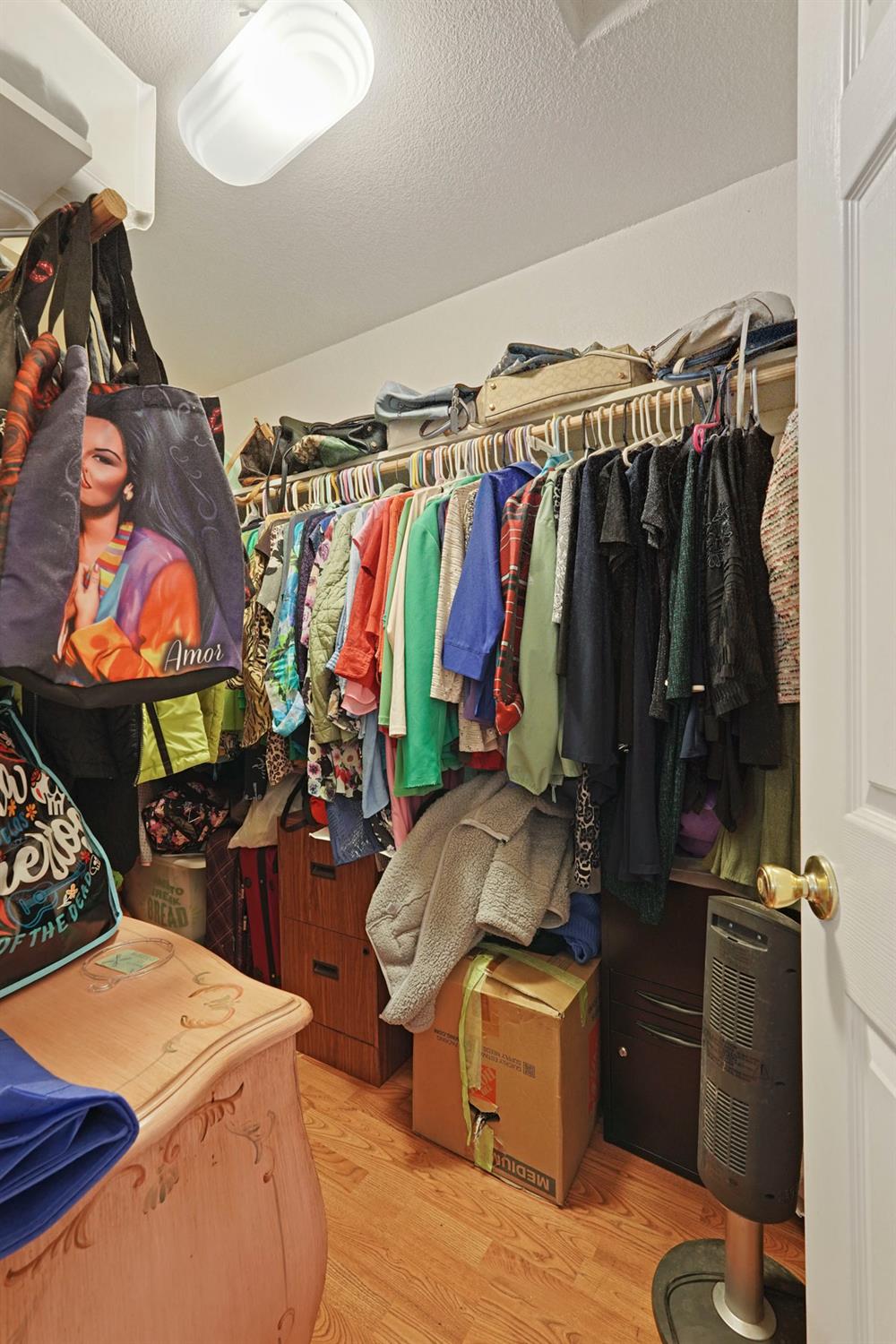 1234 Perry Avenue Stockton, CA 95203 - Photo 24 of 30 a view of walk in closet with clothes and shoes