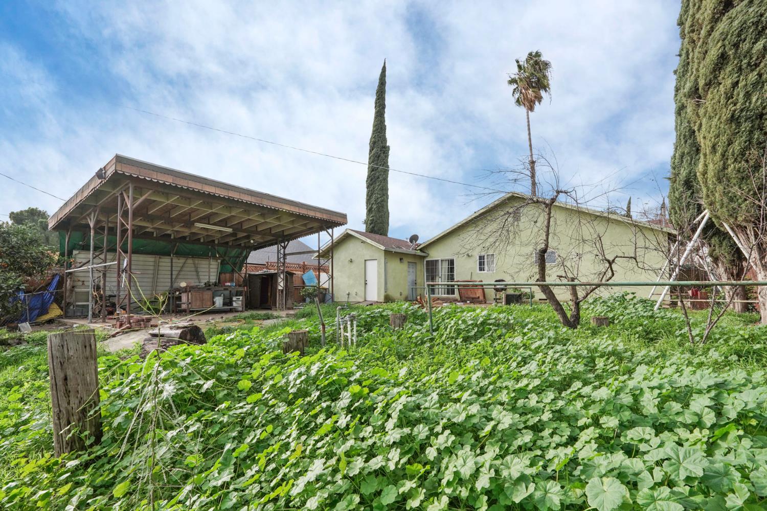 1234 Perry Avenue Stockton, CA 95203 - Photo 27 of 30 a view of a house with a small yard and plants