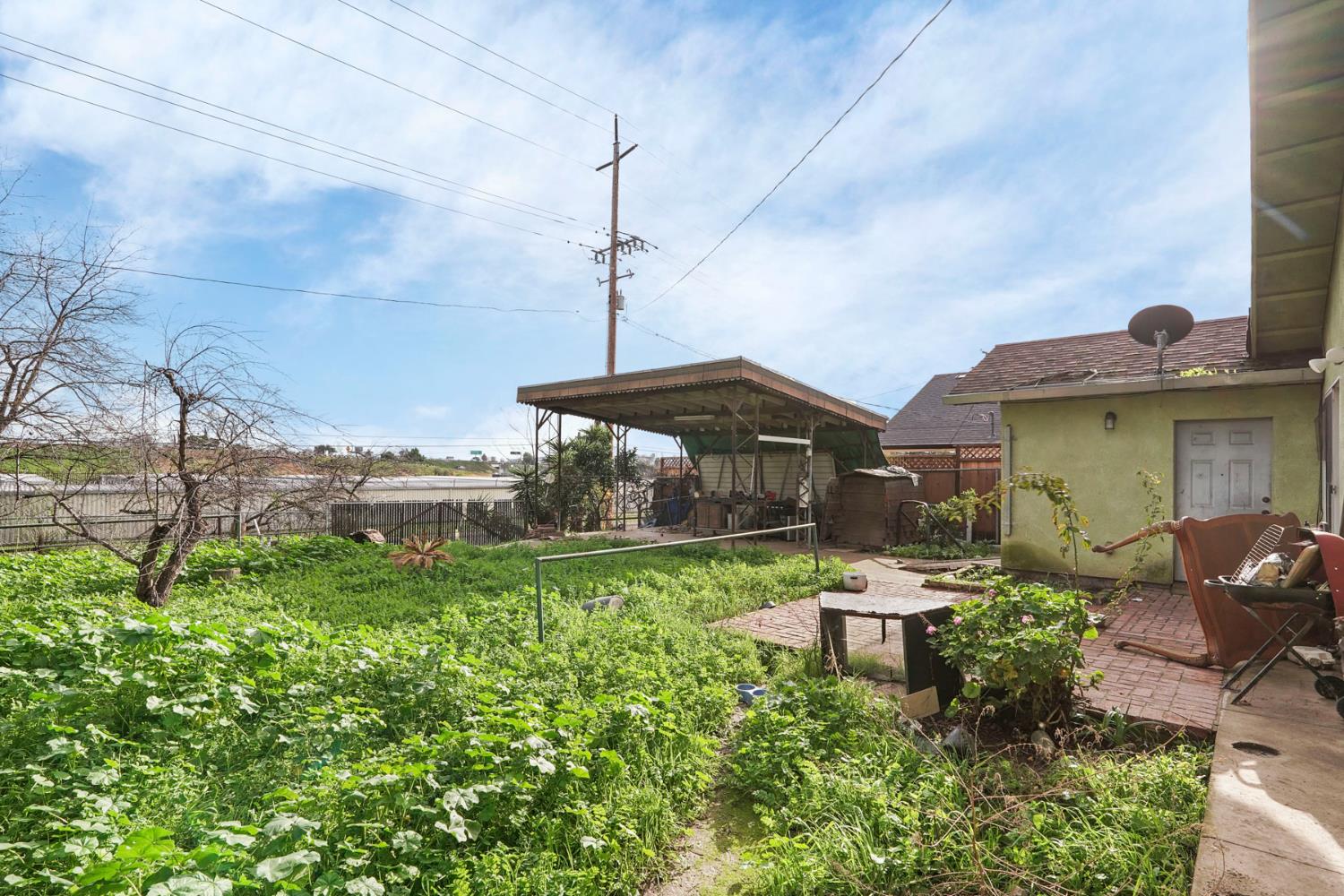 1234 Perry Avenue Stockton, CA 95203 - Photo 28 of 30 a front view of a house with a garden