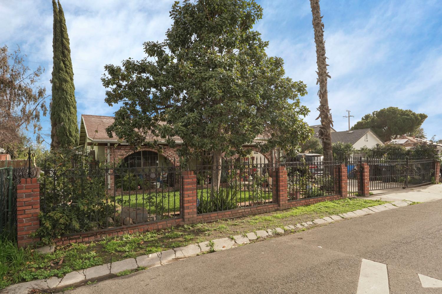 1234 Perry Avenue Stockton, CA 95203 - Photo 3 of 30 a view of a street with brick building in front of it