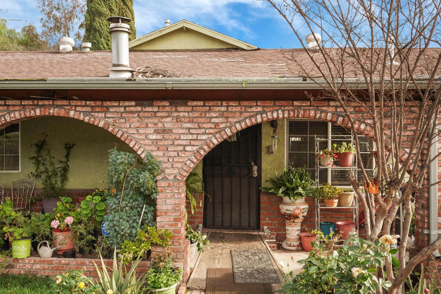 1234 Perry Avenue Stockton, CA 95203 - Photo 5 of 30 a front view of a house with a garden