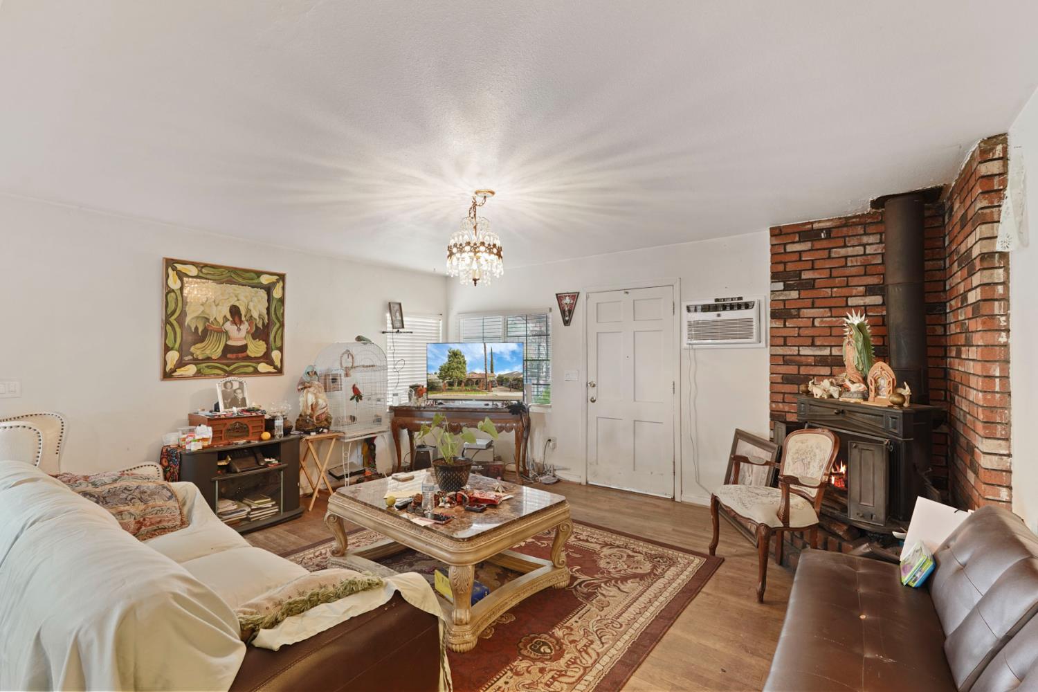 1234 Perry Avenue Stockton, CA 95203 - Photo 8 of 30 a living room with furniture and a chandelier