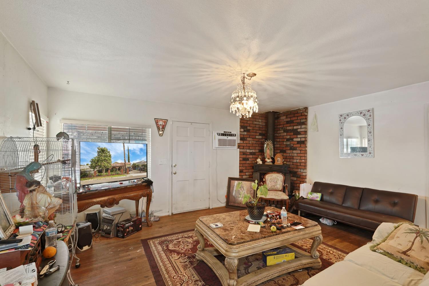 1234 Perry Avenue Stockton, CA 95203 - Photo 9 of 30 a living room with furniture and a chandelier