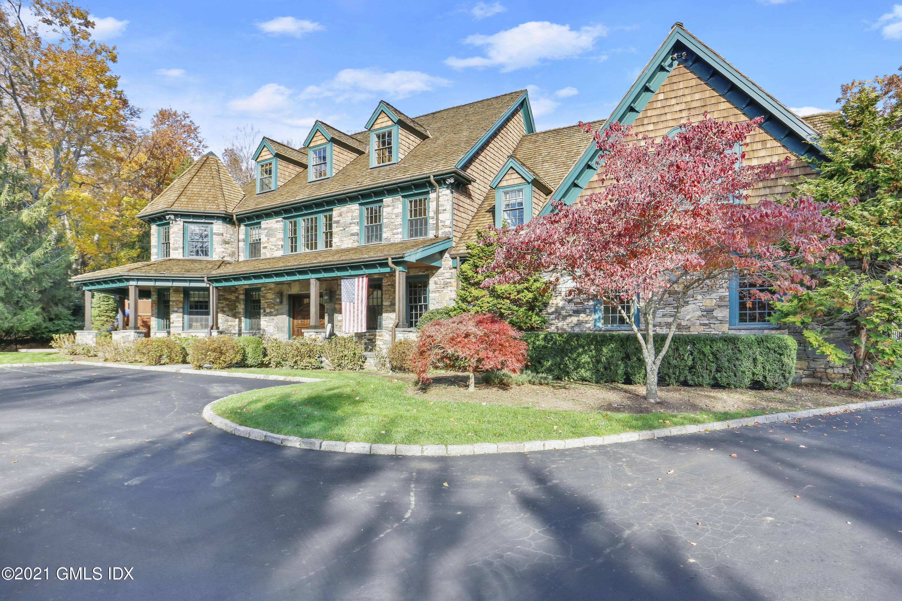 142 Cat Rock Road Cos Cob, CT 06807 - Photo 1 of 27 a front view of a house with a yard and garage