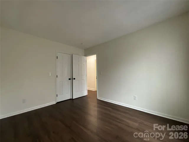 a view of an empty room and wooden floor