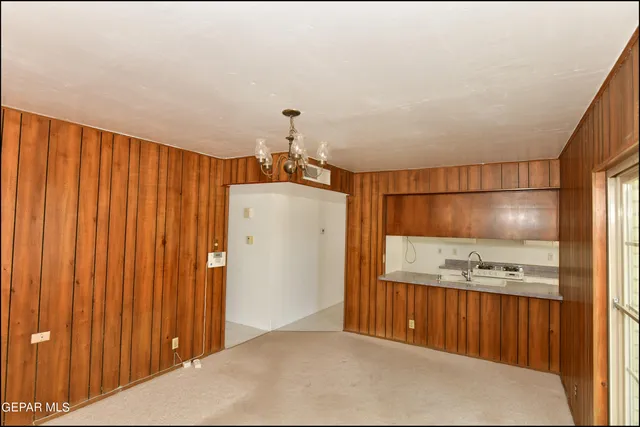 a kitchen with a stove a sink and cabinets