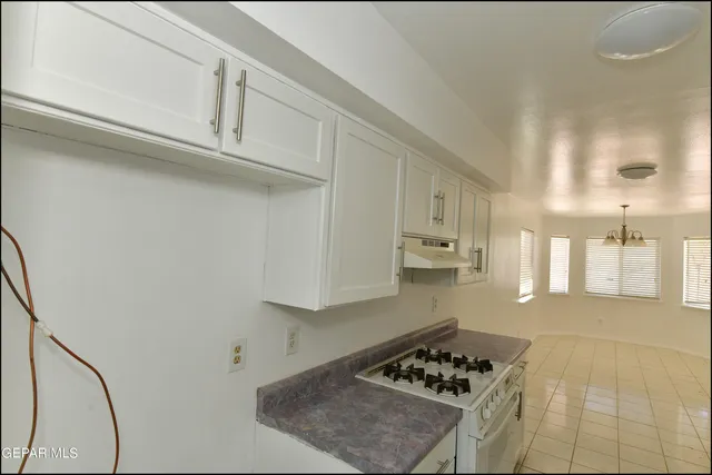 a kitchen with white cabinets and white appliances