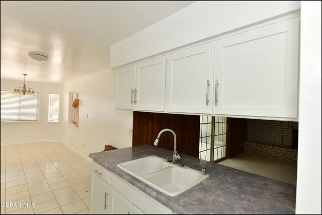 a kitchen with a sink and cabinets