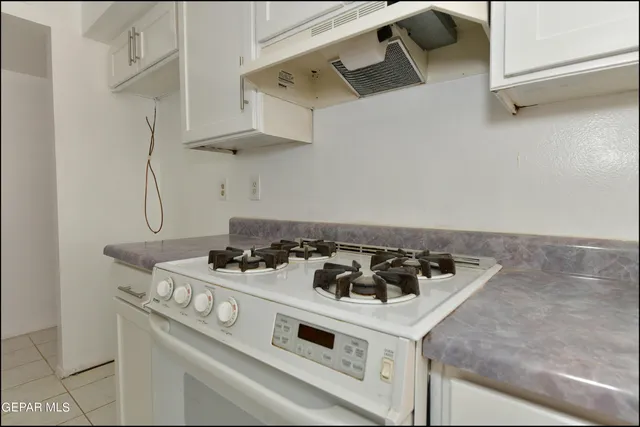 a kitchen that has a sink and a stove