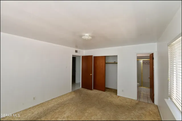 a bathroom with a toilet and shower