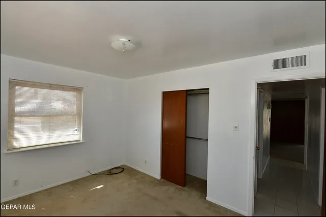 a view of a room with wall painting and a window