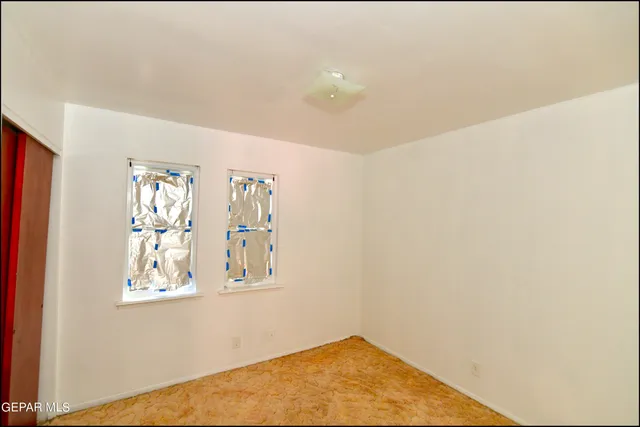 a view of a porch with wooden floor and a yard