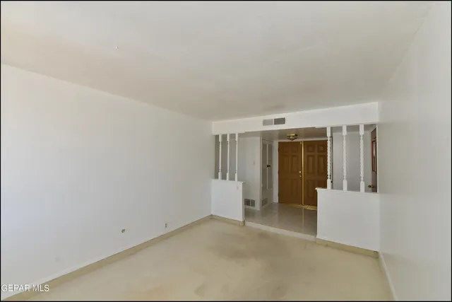 a view of an empty room with a fireplace