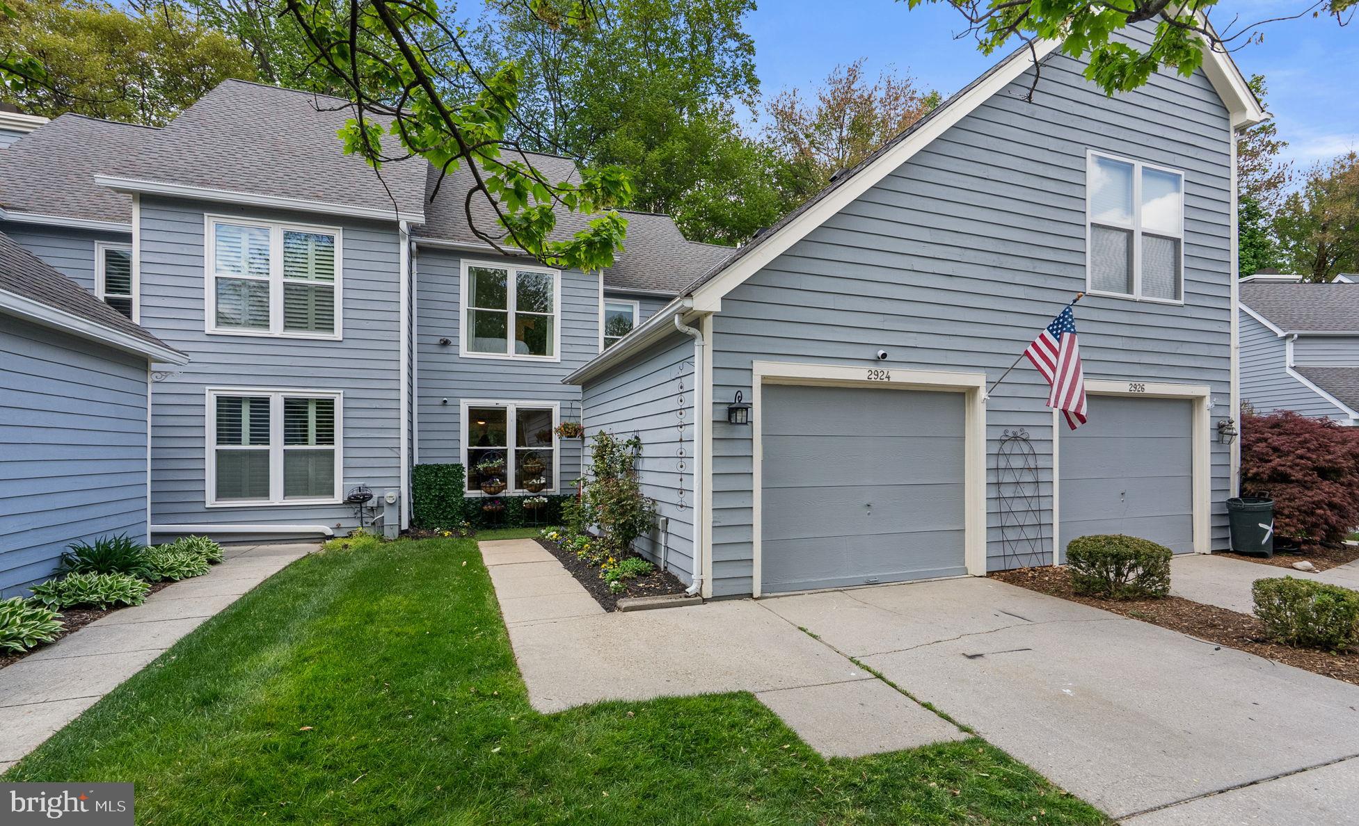 2924 Winters Chase Way Annapolis, MD 21401 - Photo 2 of 67 a front view of a house with a yard and garage