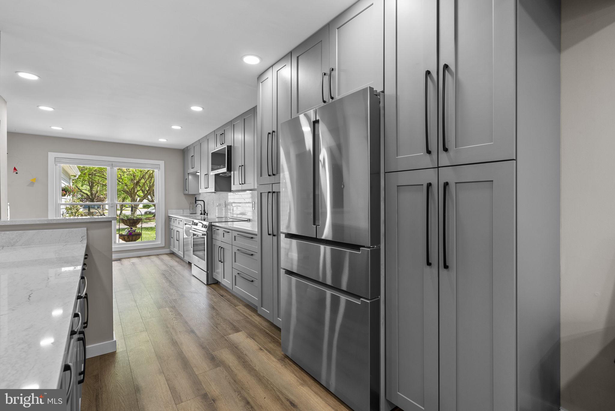 2924 Winters Chase Way Annapolis, MD 21401 - Photo 33 of 67 a kitchen with stainless steel appliances a refrigerator a sink cabinets and wooden floor