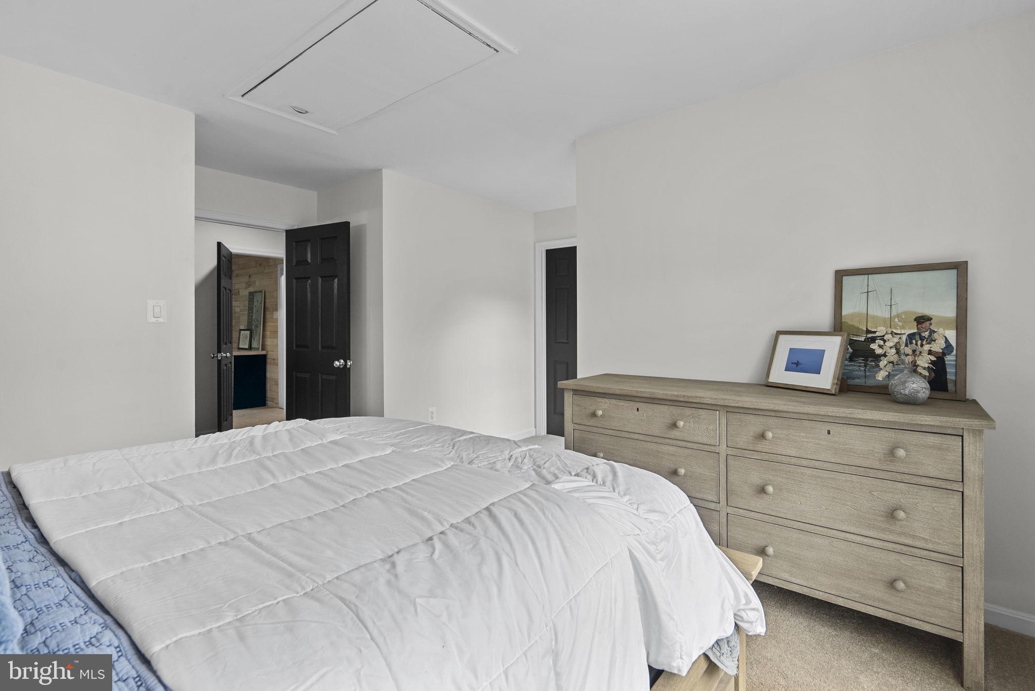 2924 Winters Chase Way Annapolis, MD 21401 - Photo 46 of 67 a bedroom with a large bed and a dresser