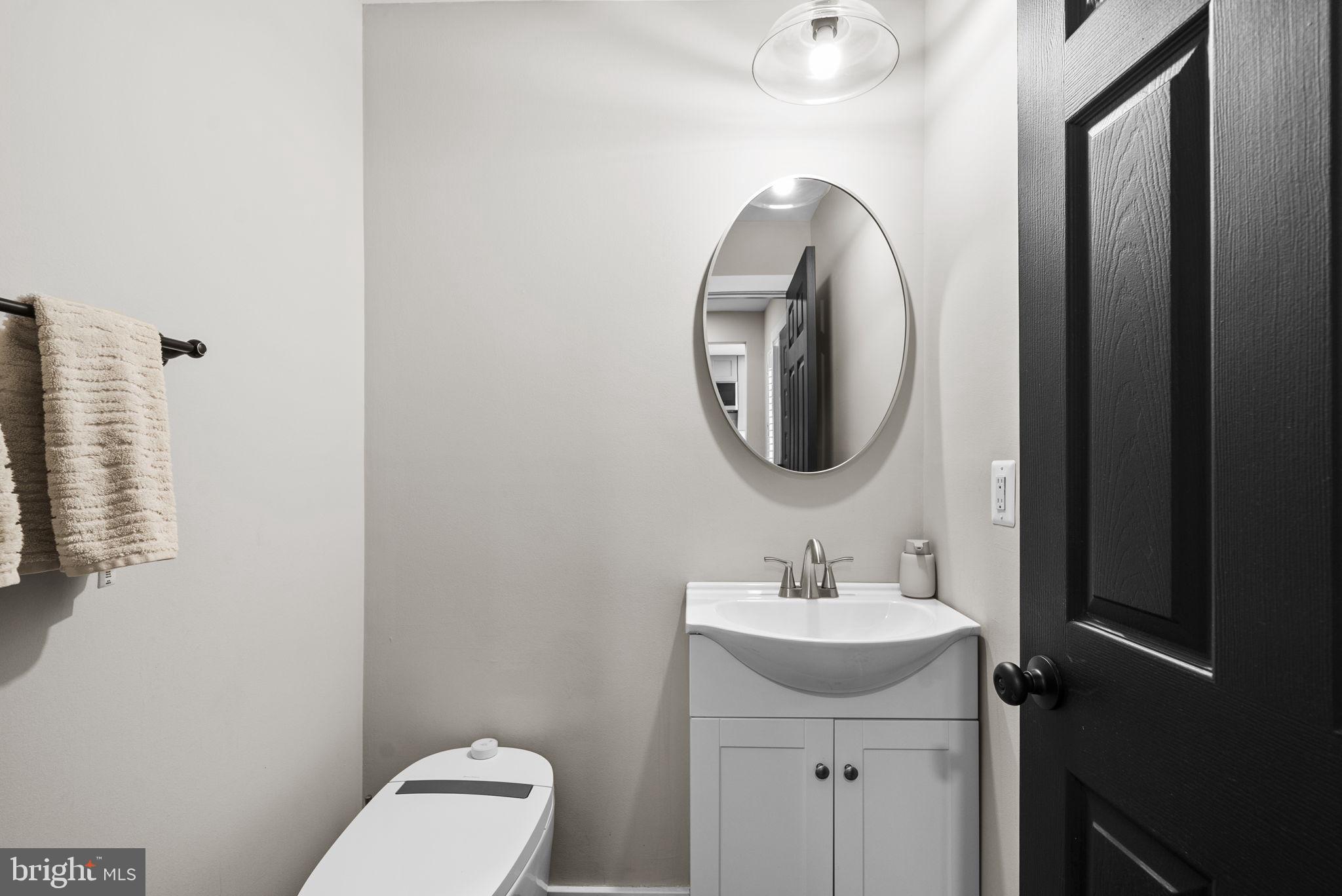 2924 Winters Chase Way Annapolis, MD 21401 - Photo 47 of 67 a bathroom with a toilet sink and mirror