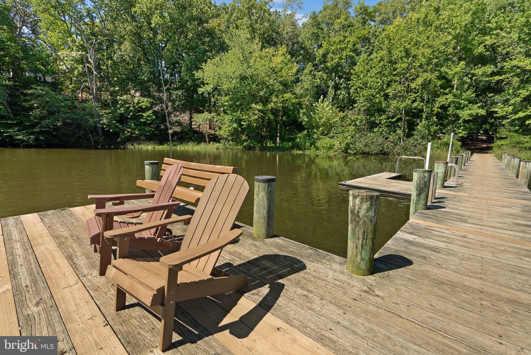 2924 Winters Chase Way Annapolis, MD 21401 - Photo 51 of 67 a view of a lake with wooden deck and a floor to ceiling window